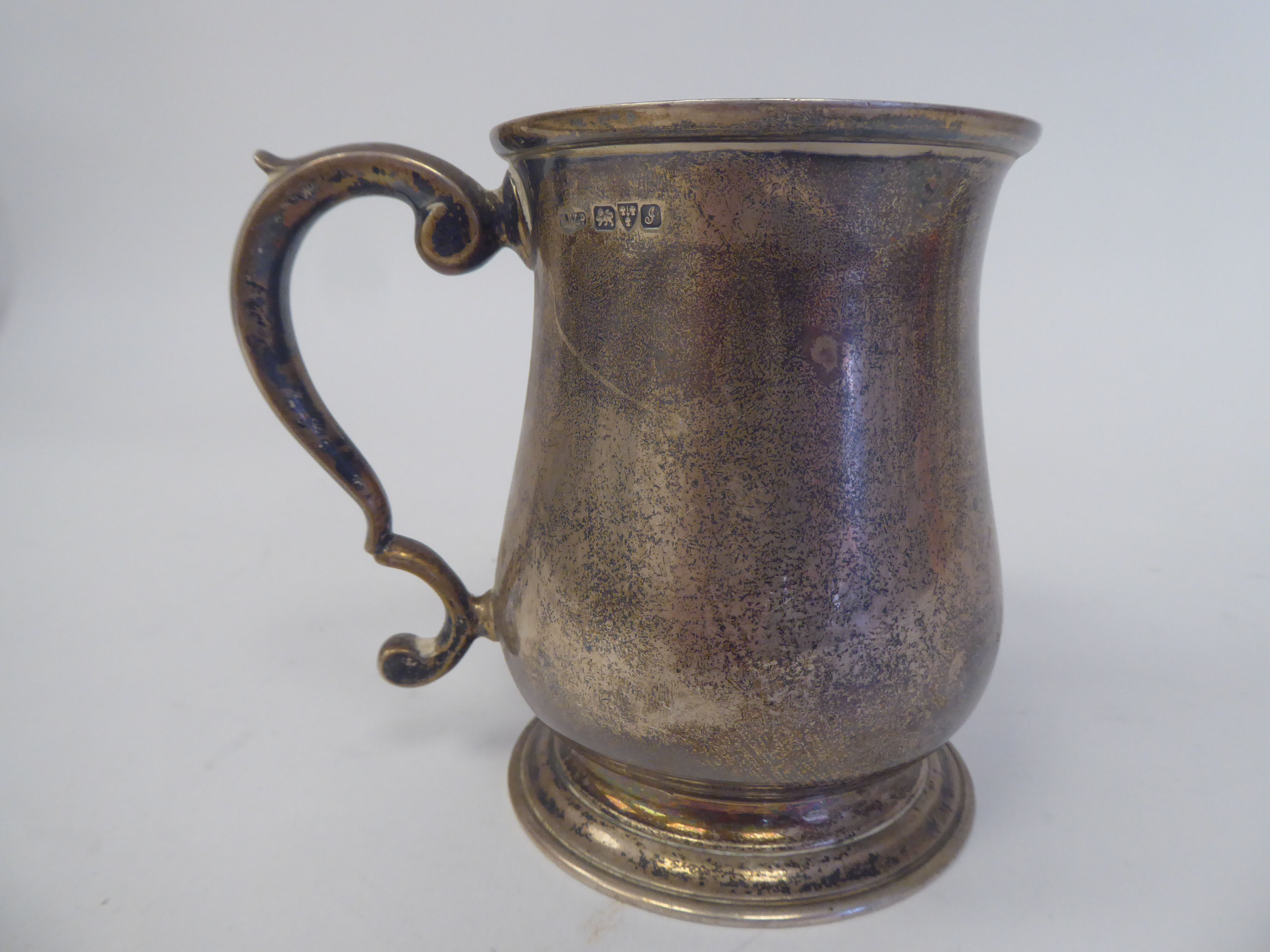 An Edwardian silver Christening mug of baluster form with a hollow, double C-scrolled handle, on a - Image 2 of 3