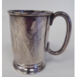 A silver Christening mug with a rolled rim and hollow C-scrolled handle, on a splayed footrim  Henry