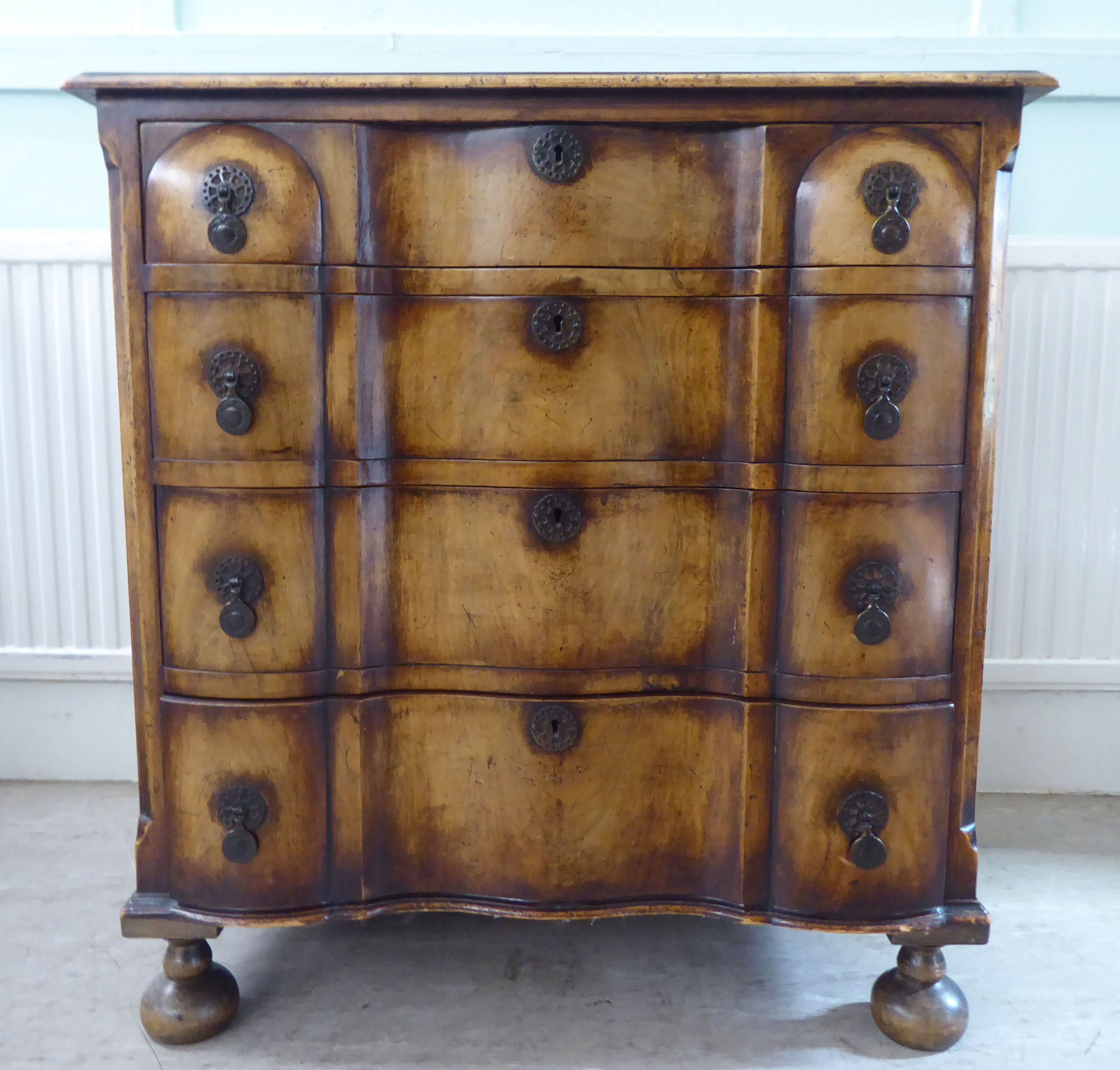 An early 20thC Continental walnut moulded block front chest, comprising four graduated long