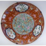 A 19thC Chinese porcelain charger, decorated to the centre with songbirds and flora and border