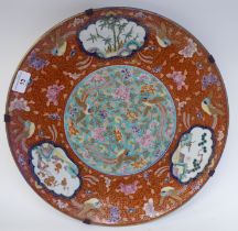 A 19thC Chinese porcelain charger, decorated to the centre with songbirds and flora and border