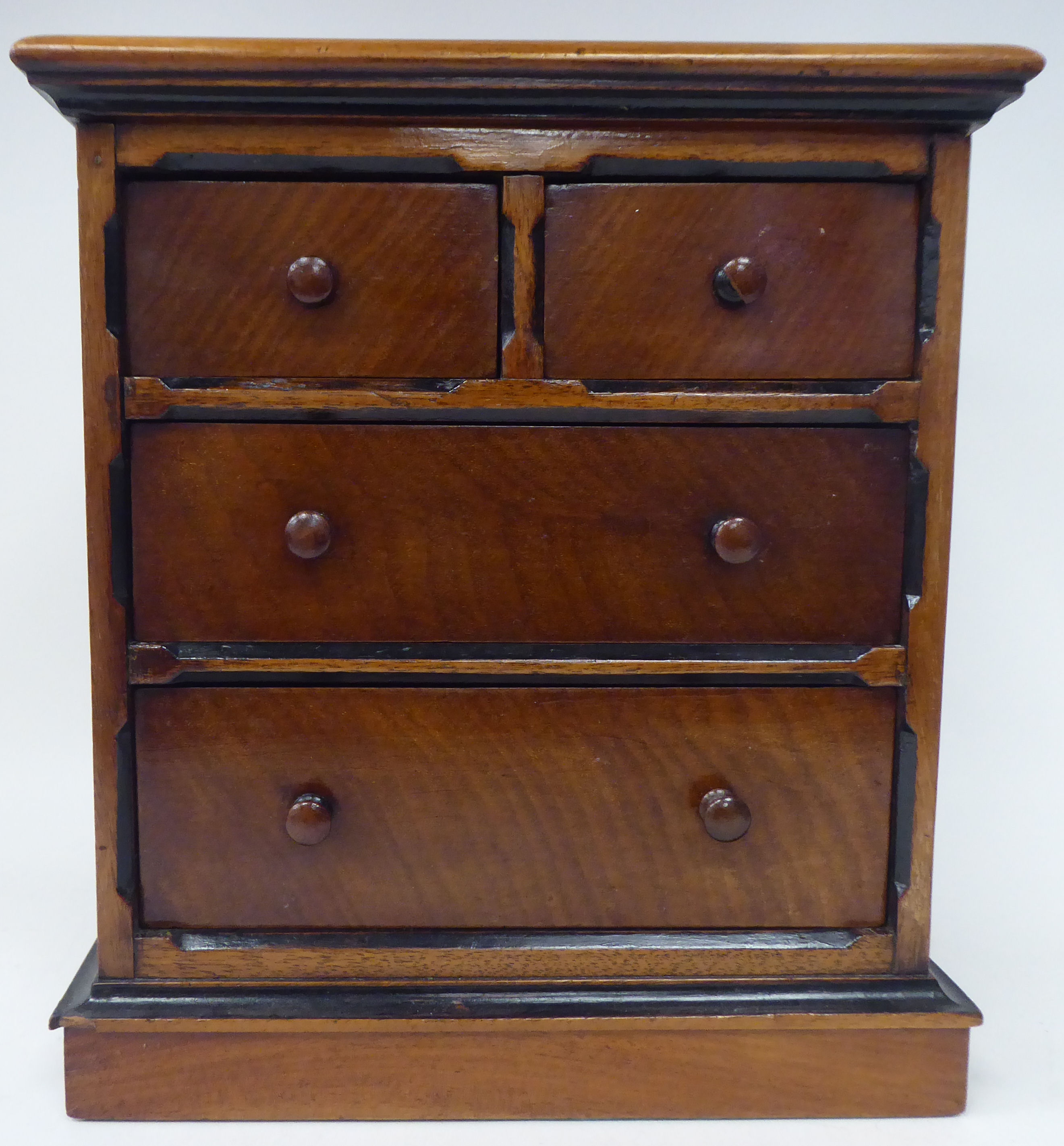 A late Victorian mahogany table top collector's chest, featuring an arrangement of five drawers with