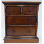 A late Victorian mahogany table top collector's chest, featuring an arrangement of five drawers with