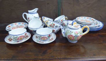 Quimper pottery tea and dinnerware, decorated with flora