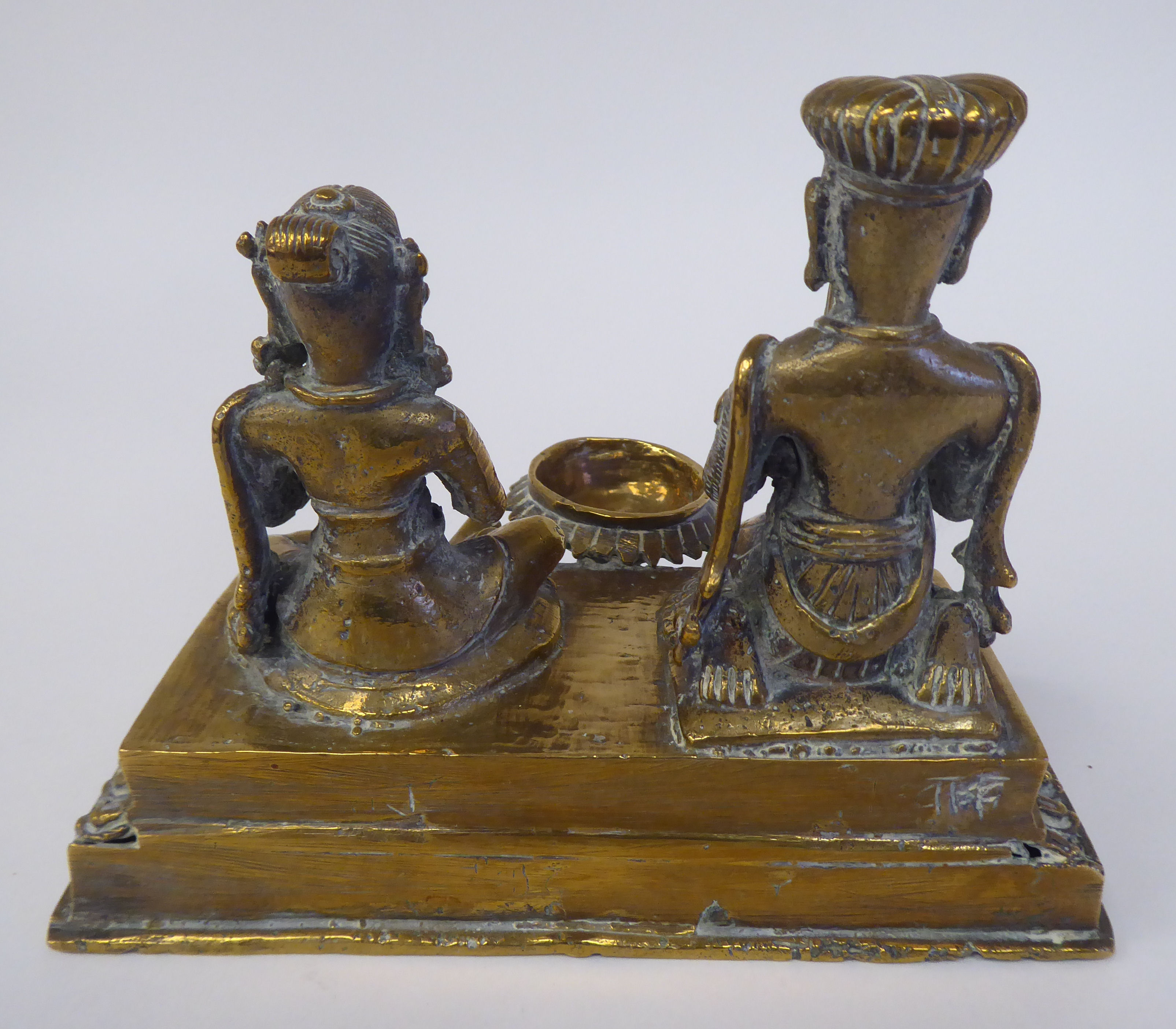 A pair of Asian brass religious deities, seated on a plinth between an outset pedestal vase  5"h - Image 3 of 4