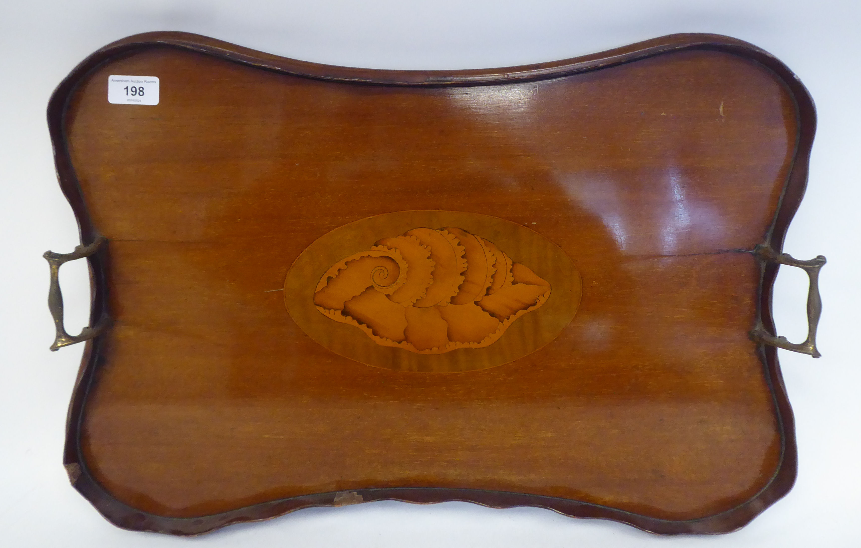 A late Victorian/Edwardian mahogany galleried serving tray of serpentine outline with a central