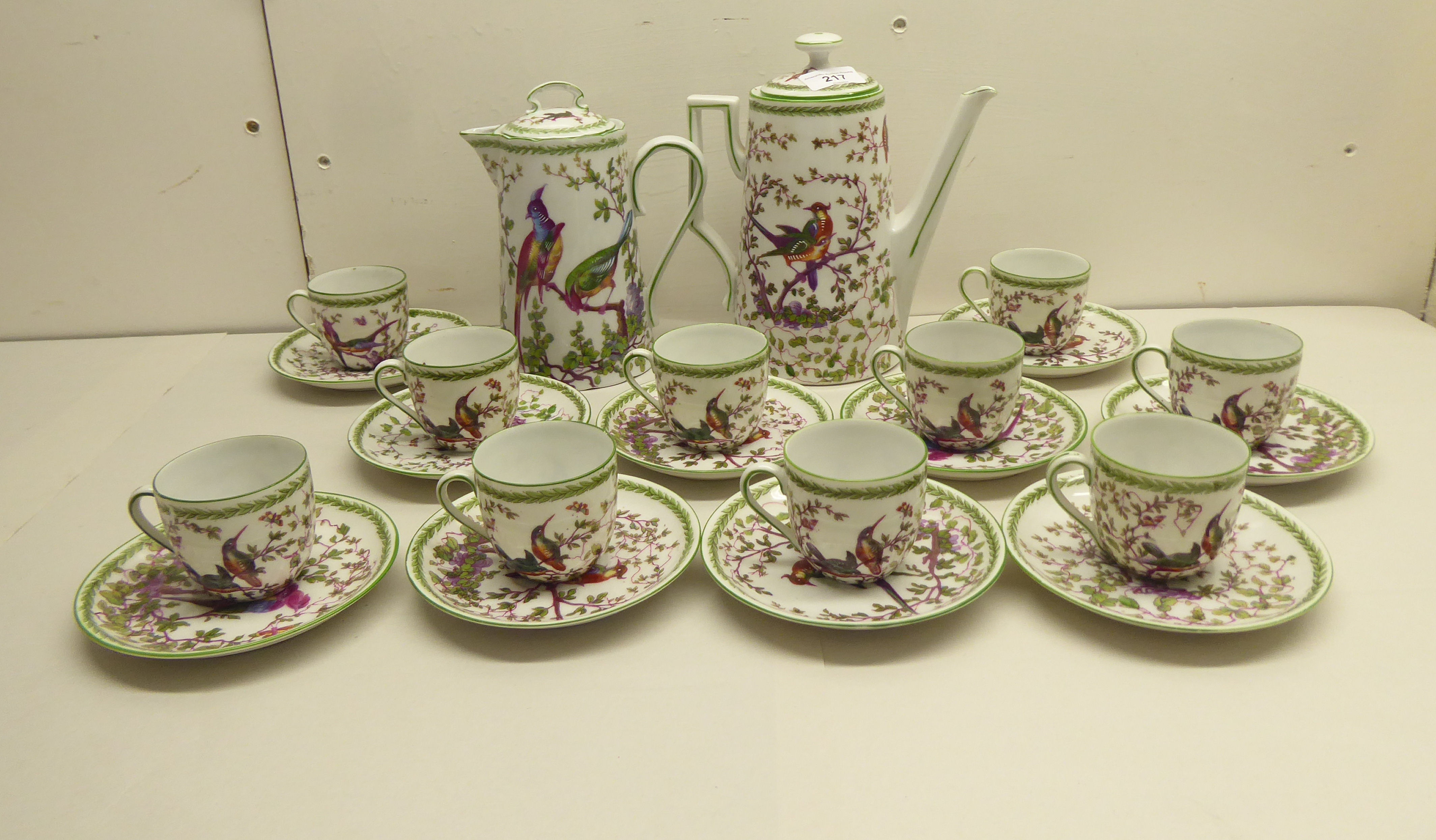 English china, decorated with birds and foliage  comprising a tea and coffee pot with ten cups and