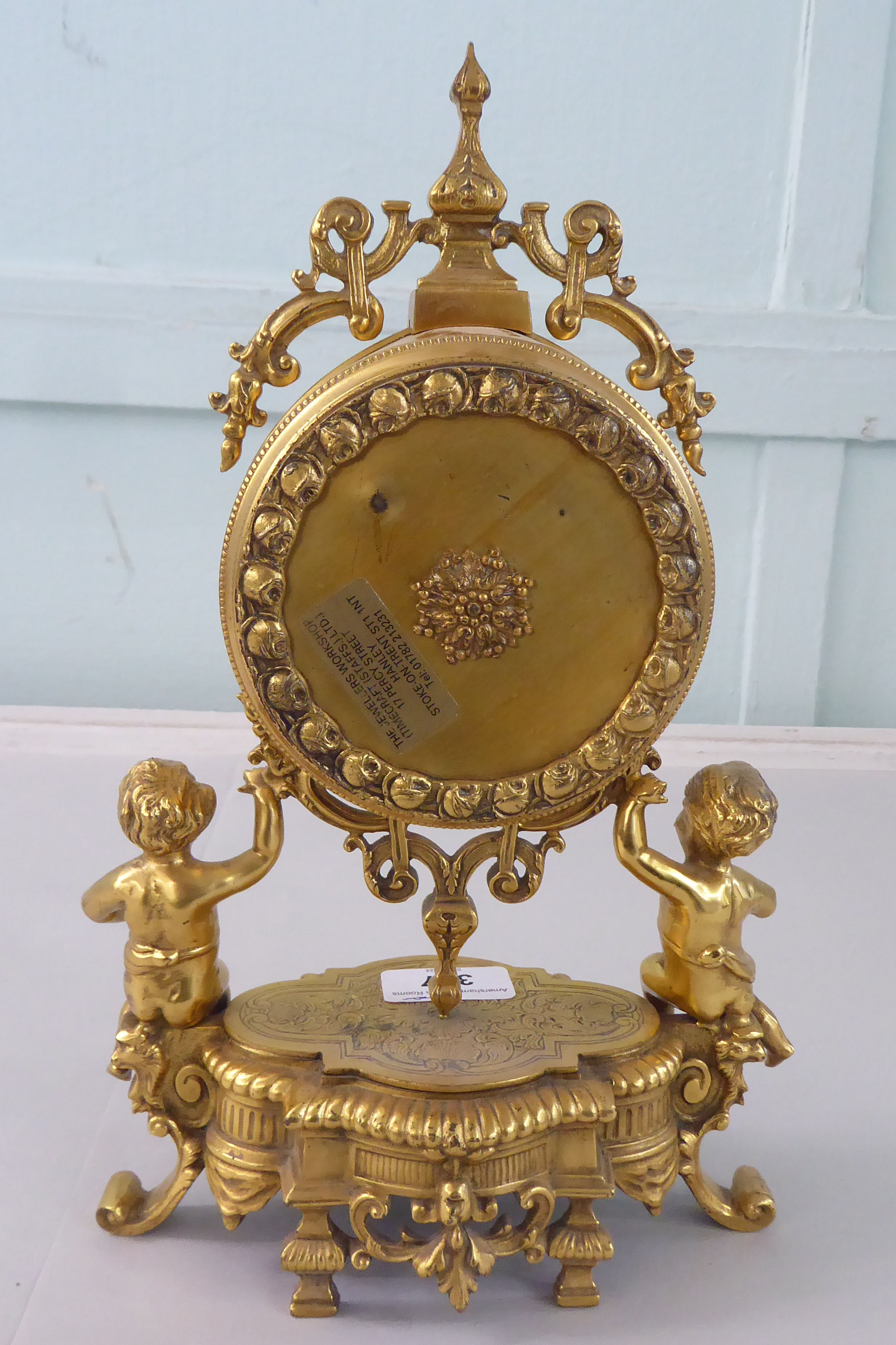 A mid 20thC Victorian design gilt metal mantel clock; the drum design movement faced by an enamelled - Image 4 of 7