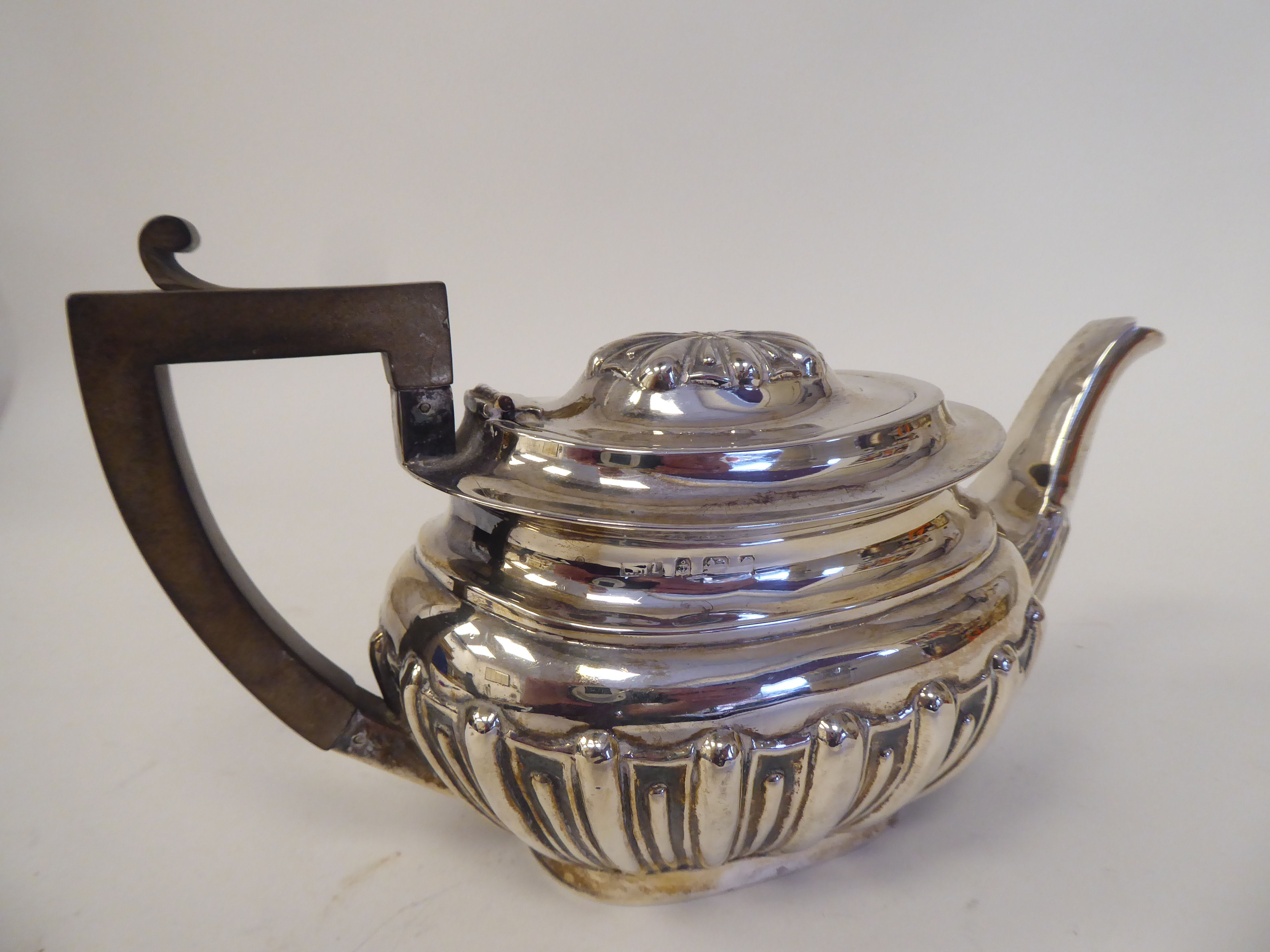 An early 20thC silver bachelors teapot of oval, demi-reeded and stop-fluted form with a swept spout, - Image 2 of 3