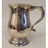 A silver one pint mug of baluster form with an S-scrolled hollow handle, on a deep footrim  AT