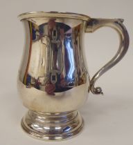 A silver one pint mug of baluster form with an S-scrolled hollow handle, on a deep footrim  AT