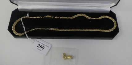 A 14ct gold flexible, fancy link neckchain, on a double dog clip clasp