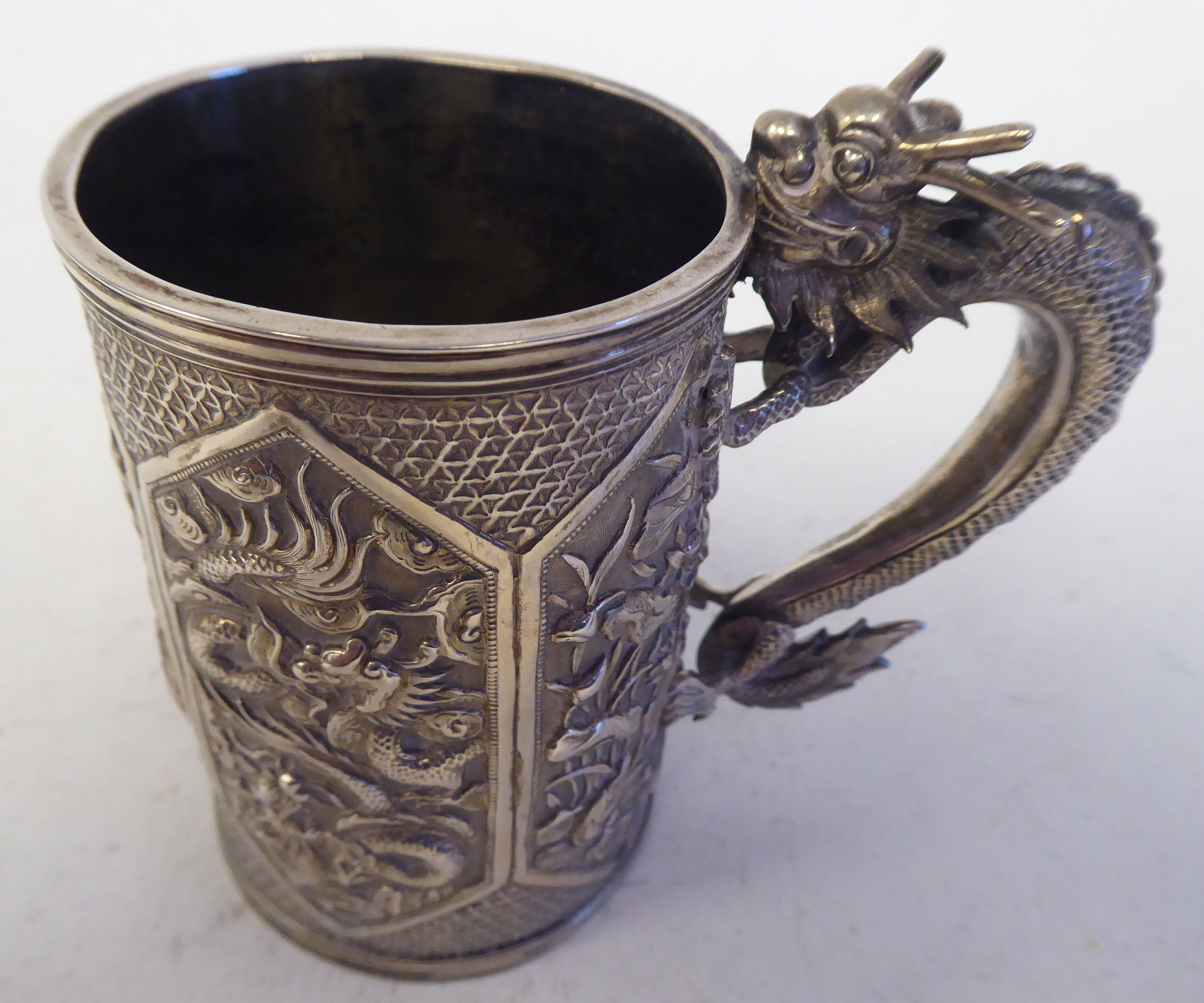 A late 19thC Chinese silver coloured metal mug of tapered cylindrical form with a cast S-shape - Image 2 of 4
