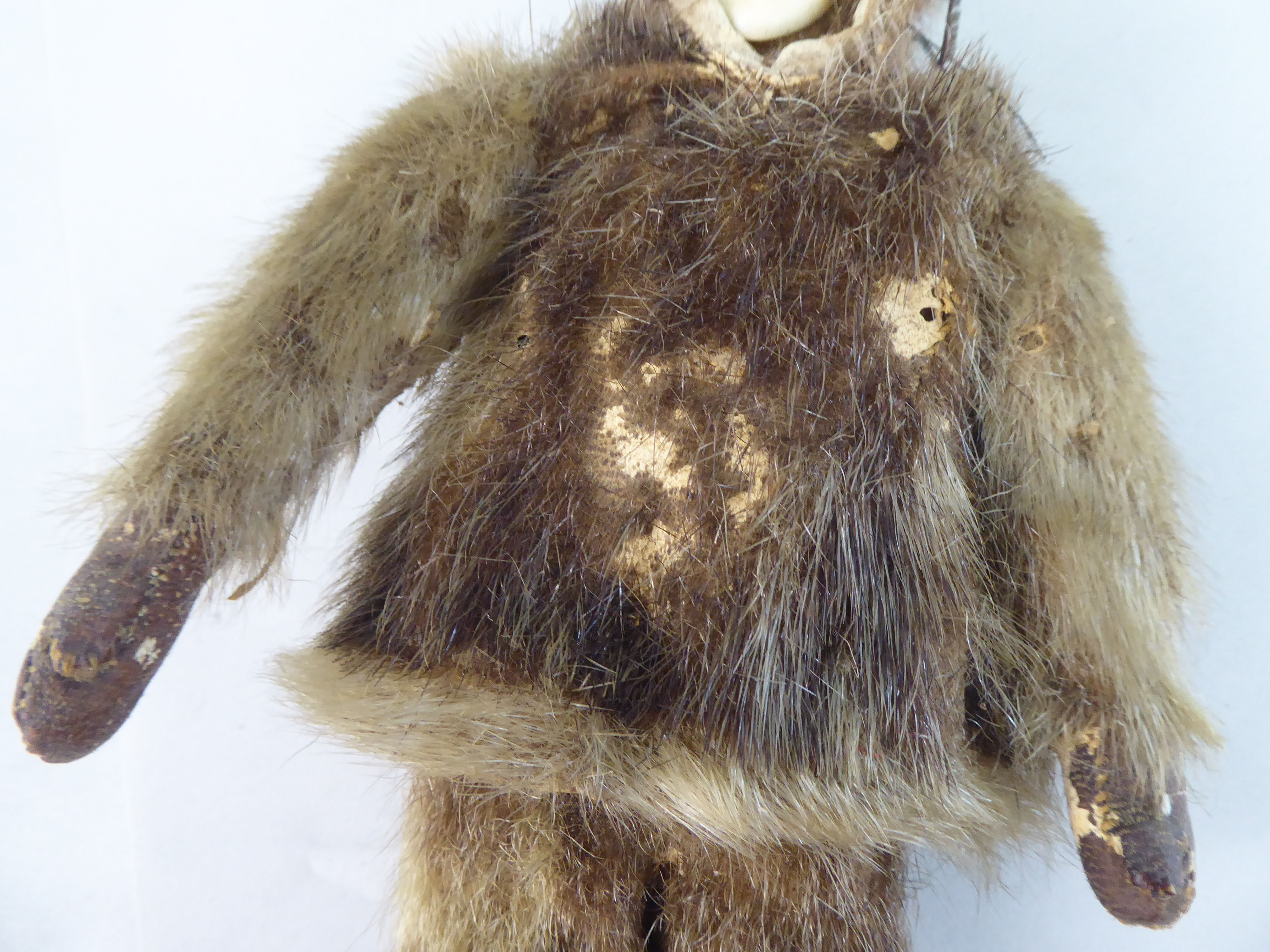 An early 20thC Inuit doll with a carved bone face and seal skin clothes  10.5"h - Image 3 of 4