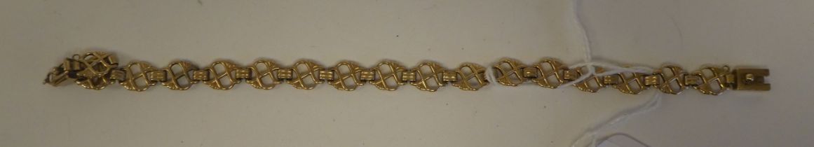 A 9ct gold pierced tablet link bracelet