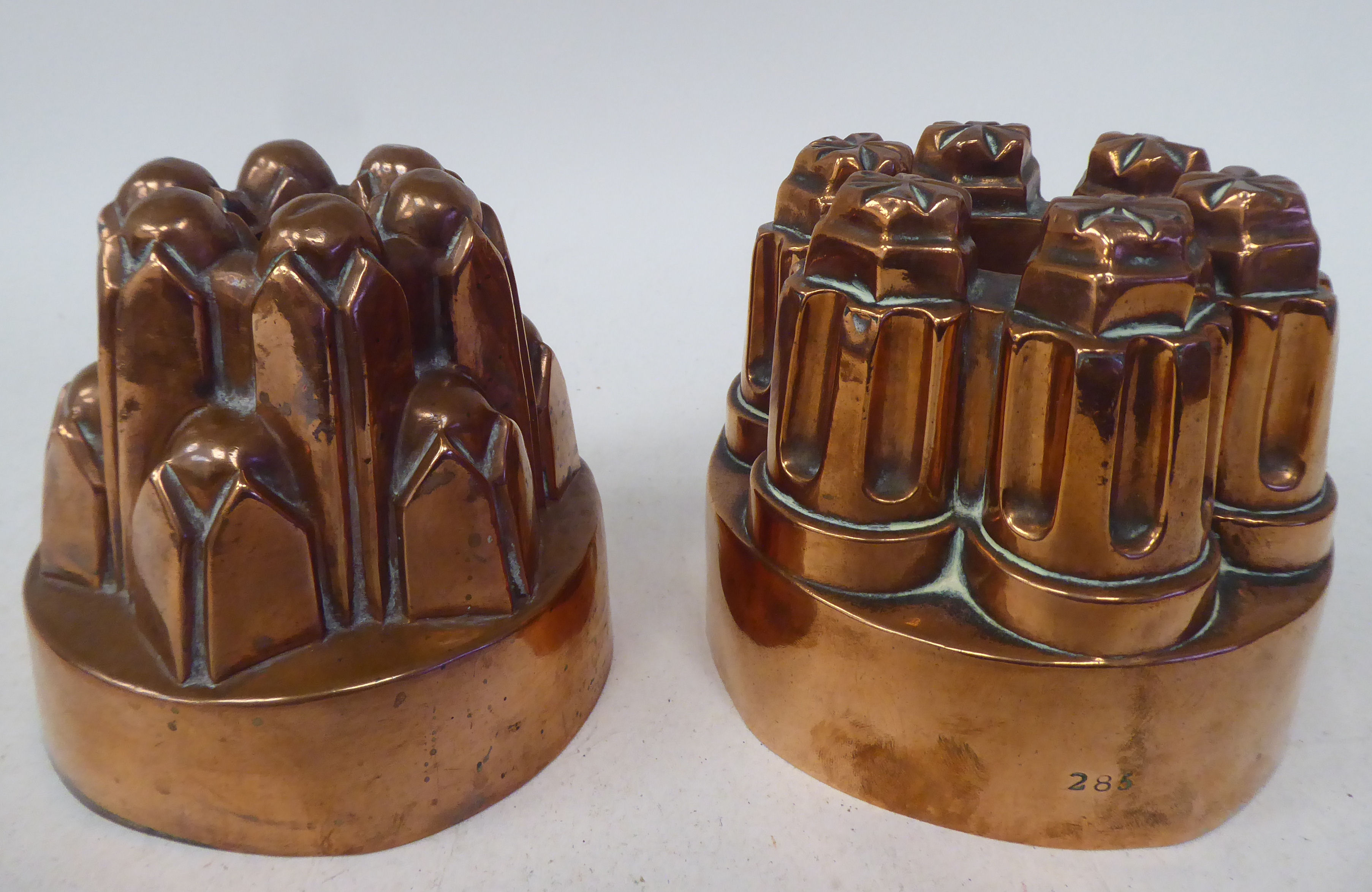 A 19thC copper, circular jelly mould of circular turret design  5"dia; and another, similar  5.25"