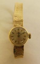 A lady's Omega 9ct gold bracelet watch, faced by a baton dial