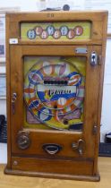 A vintage penny-in-the-slot, mechanical 'Playball' bagatelle machine, in a wall mountable light