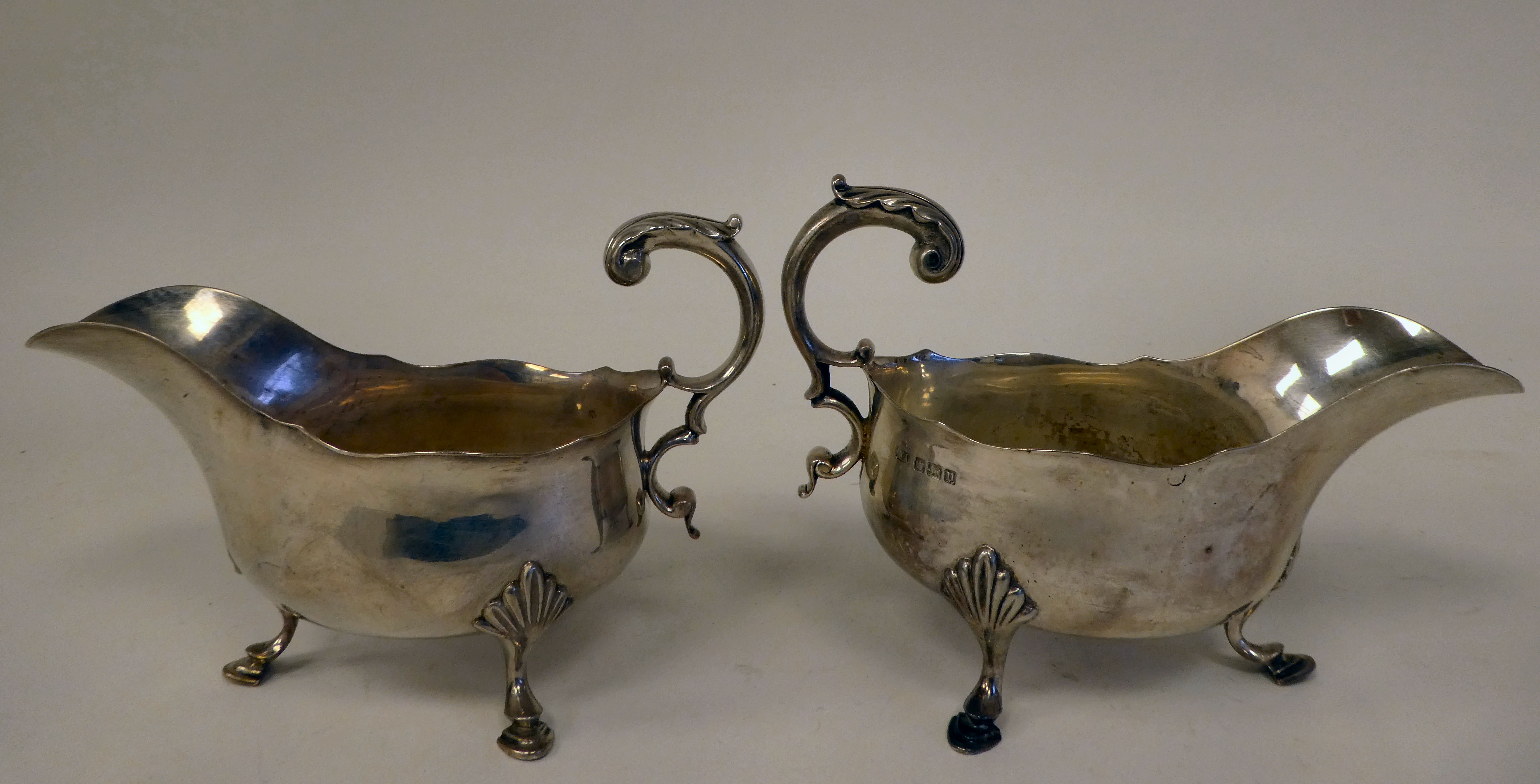 A pair of silver sauce boats with cut, wavy rims and double C-scrolled handles, elevated on shell - Image 2 of 4