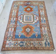 A Turkish Azari style rug, decorated in bright colours with stylised designs  69" x 101"