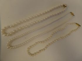 Three single string pearl necklaces, on 9ct gold clasps