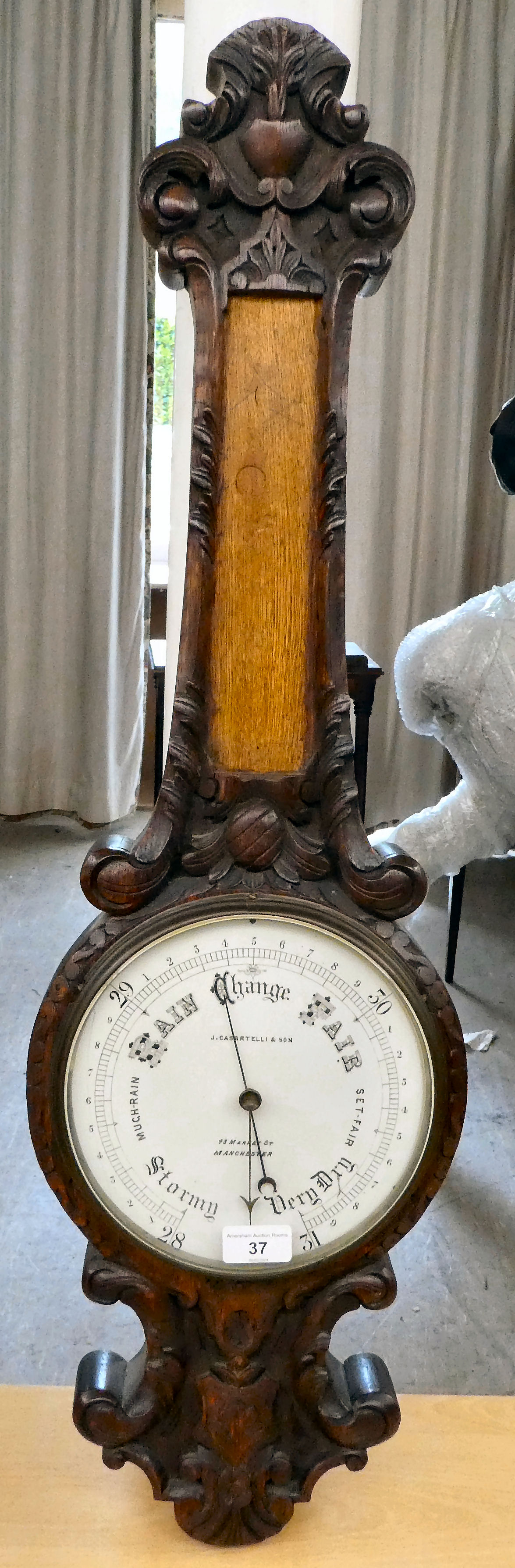 A 1930s oak cased barometer, the dial inscribed J Casartelli & Son of Manchester  34"h