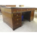 An early 20thC string inlaid mahogany, twin pedestal partner's desk with an arrangement of drawers