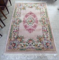 A Chinese wash rug, decorated in pastel tones, on a multi-coloured ground  49" x 74"