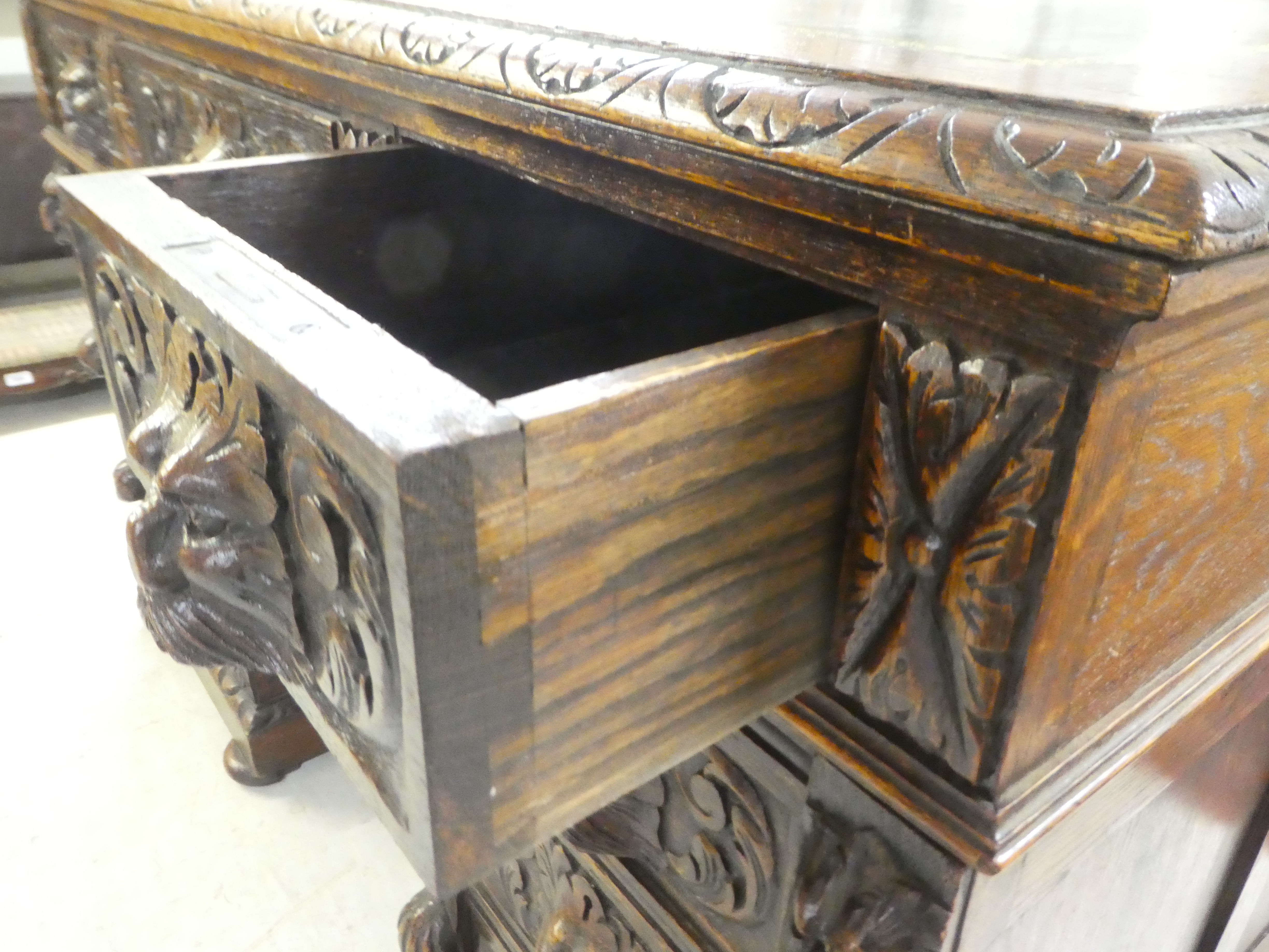 A late Victorian carved oak, nine drawer, twin pedestal desk, on a plinth and bun feet  31"h  47"w - Image 6 of 8