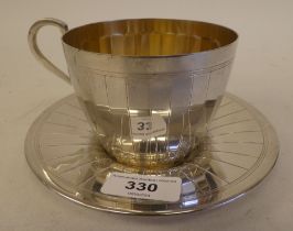 A Continental white metal presentation cup and saucer