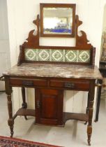 An Edwardian mahogany tiled and marble washstand, raised on turned and block legs  46"h  42"w