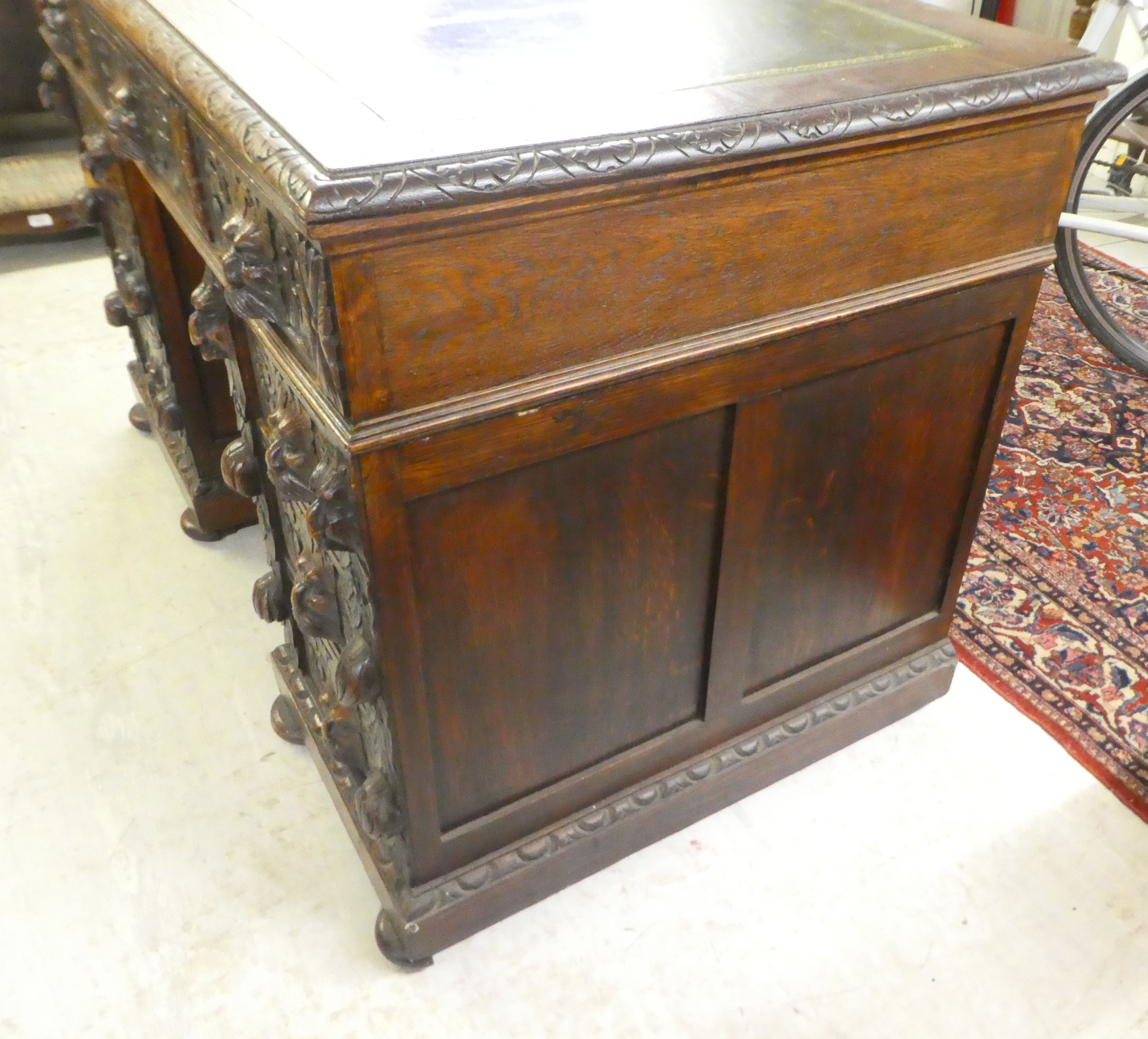A late Victorian carved oak, nine drawer, twin pedestal desk, on a plinth and bun feet  31"h  47"w - Image 4 of 8