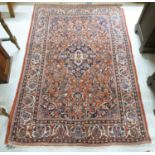 A Persian rug, profusely decorated with floral designs, on a mainly red ground  53" x 77"