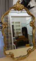 A modern mirror, the shaped plate in a moulded gilt frame  30" x 16"