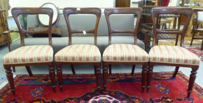 A set of four Edwardian mahogany framed bar back dining chairs, the later fabric upholstered