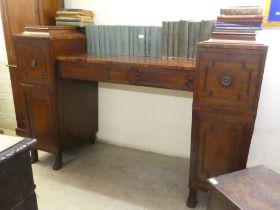 A Regency mahogany drop-well sideboard with two central drawers. flanked by pedestals, each with a