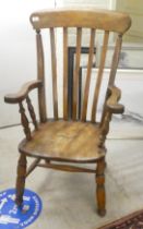 An early 20thC beech and elm high lath back, open arm chair, the solid seat raised on turned legs