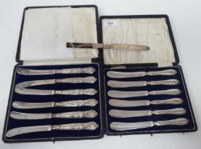 Two sets of six loaded silver handled butter knives  both boxed; and one single  mixed marks