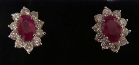 A pair of ruby and diamond set stud earrings