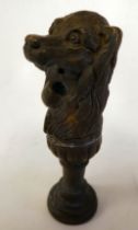 A cast bronze pipe smoker's tamper, in the form of a dog's head