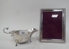 A silver sauce boat; and a silver plated photograph frame  3" x 5"