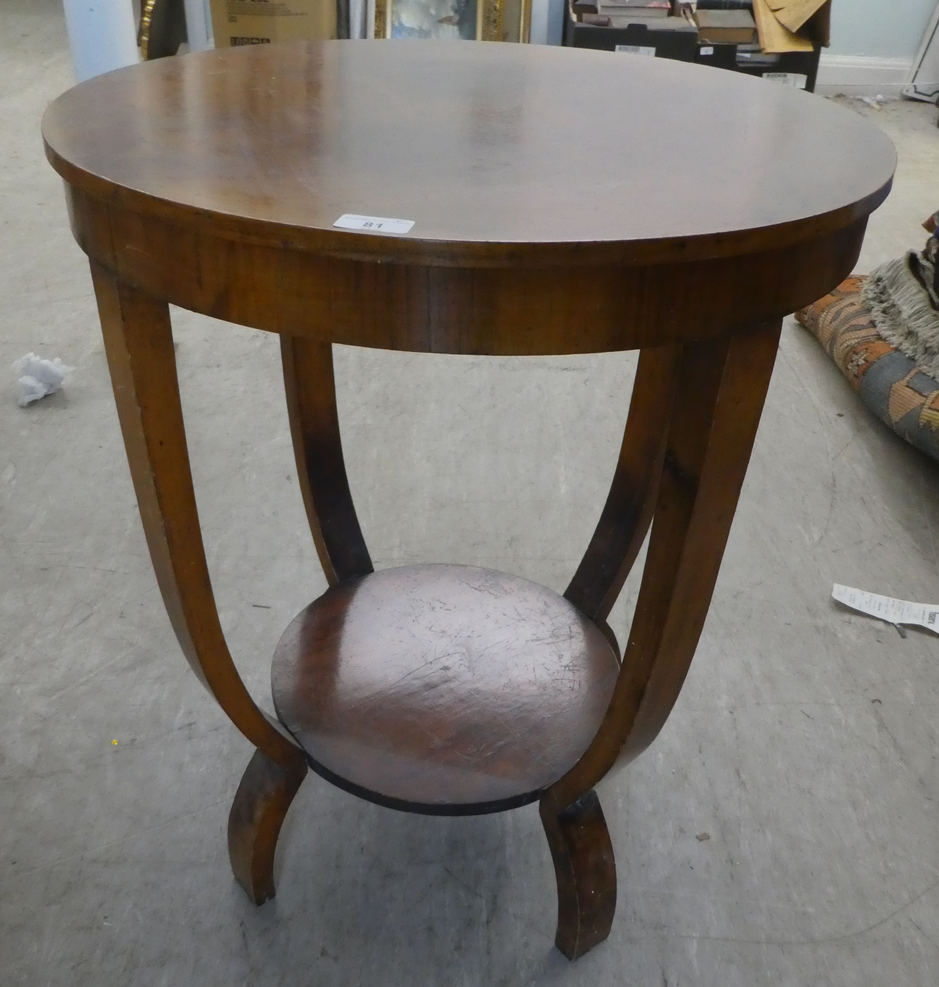 An Art Deco walnut finished two tier centre table, raised on curved legs  27"h  23"dia