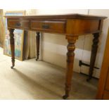 An Edwardian mahogany two drawer side table, raised on ring turned, tapered legs and casters  29"