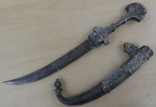 A late 19th/early 20thC Moroccan Koummya dagger, in a silvered sheath, the curved blade 11"L