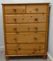 A modern pine six drawer dressing chest, on a plinth and bun feet  42"h  33"w