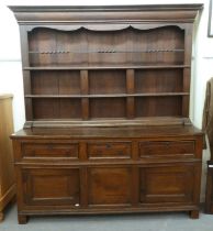 A late 18th/early 19thC stained oak dresser, the superstructure with three open plate racks, the