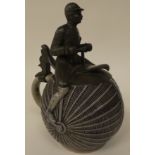 A late 19thC J Neumark Gebruder Horn stoneware stein, fashioned as a penny-farthing, the pewter