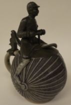 A late 19thC J Neumark Gebruder Horn stoneware stein, fashioned as a penny-farthing, the pewter