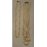 Two single strand pearl necklaces, on 9ct gold clasps