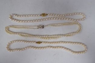 Two single string and one double string pearl necklace, all on 9ct gold clasps